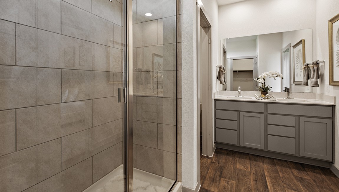 4712 Oxgang Drive Pflugerville, TX 78660 - Photo 22 of 33 a bathroom with a double vanity sink a mirror and shower