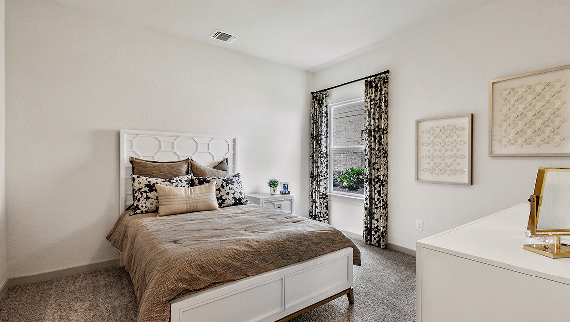 4712 Oxgang Drive Pflugerville, TX 78660 - Photo 24 of 33 a bedroom with a bed and a flat screen tv