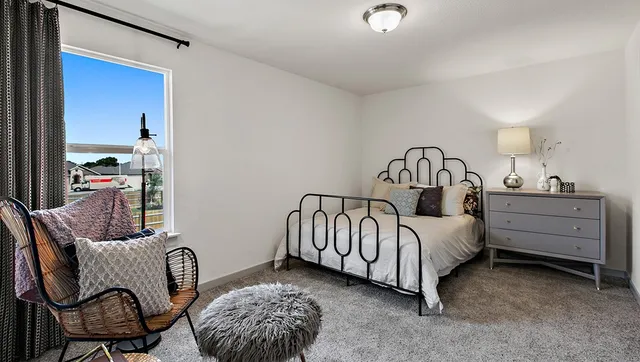a bathroom with a granite countertop sink a toilet a mirror and shower