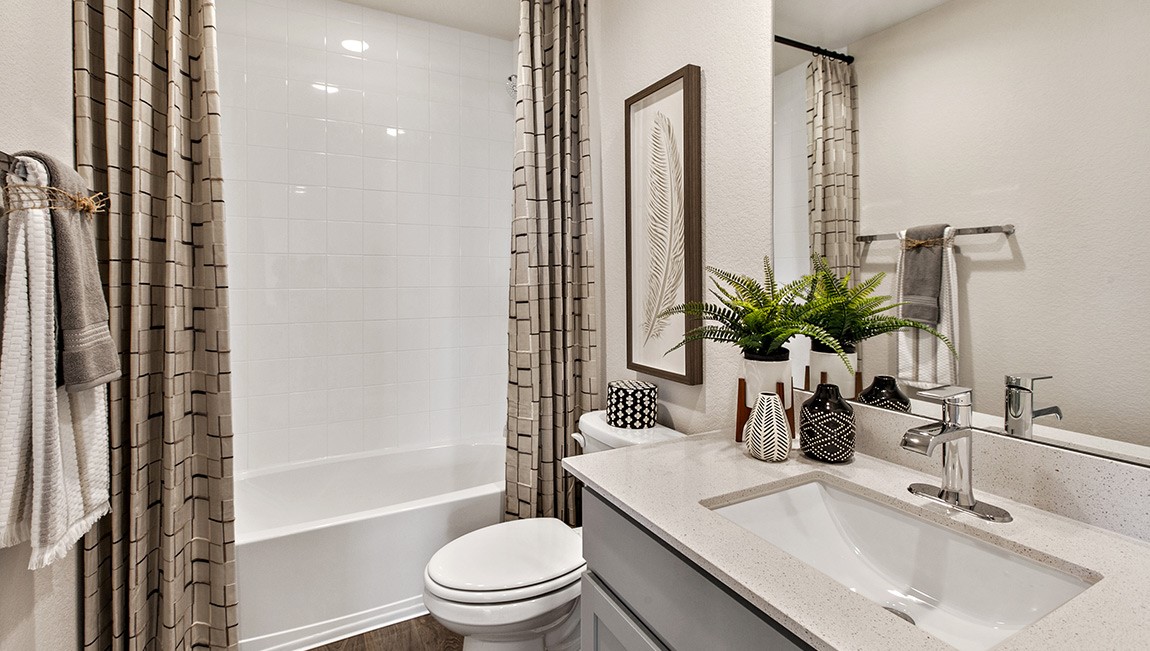 4712 Oxgang Drive Pflugerville, TX 78660 - Photo 31 of 33 a bathroom with a granite countertop sink a toilet a mirror and shower