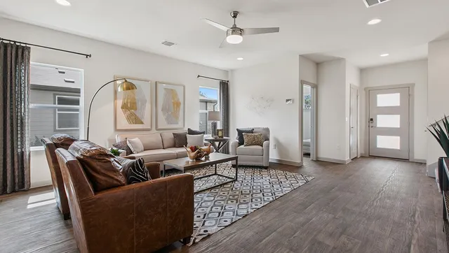 a living room with furniture and wooden floor