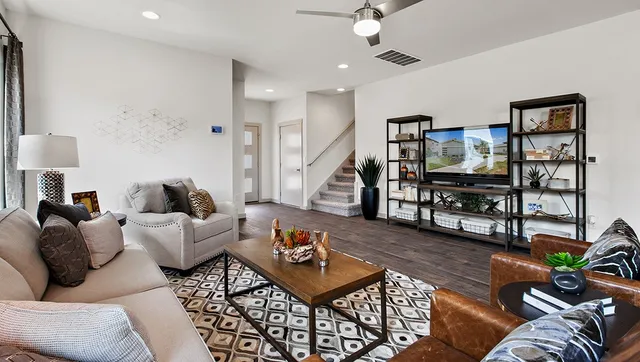 a living room with furniture and wooden floor