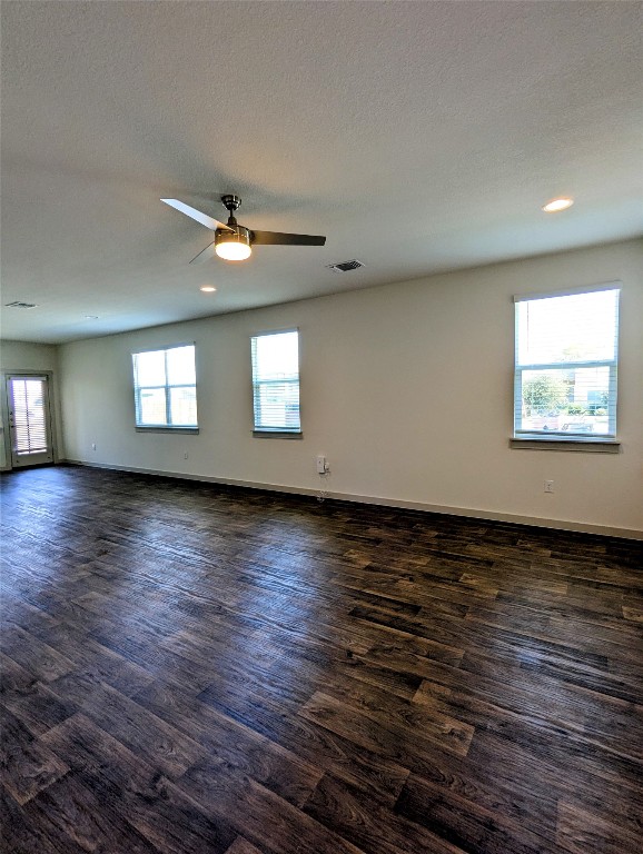 4712 Oxgang Drive Pflugerville, TX 78660 - Photo 9 of 33 an empty room with wooden floor and windows