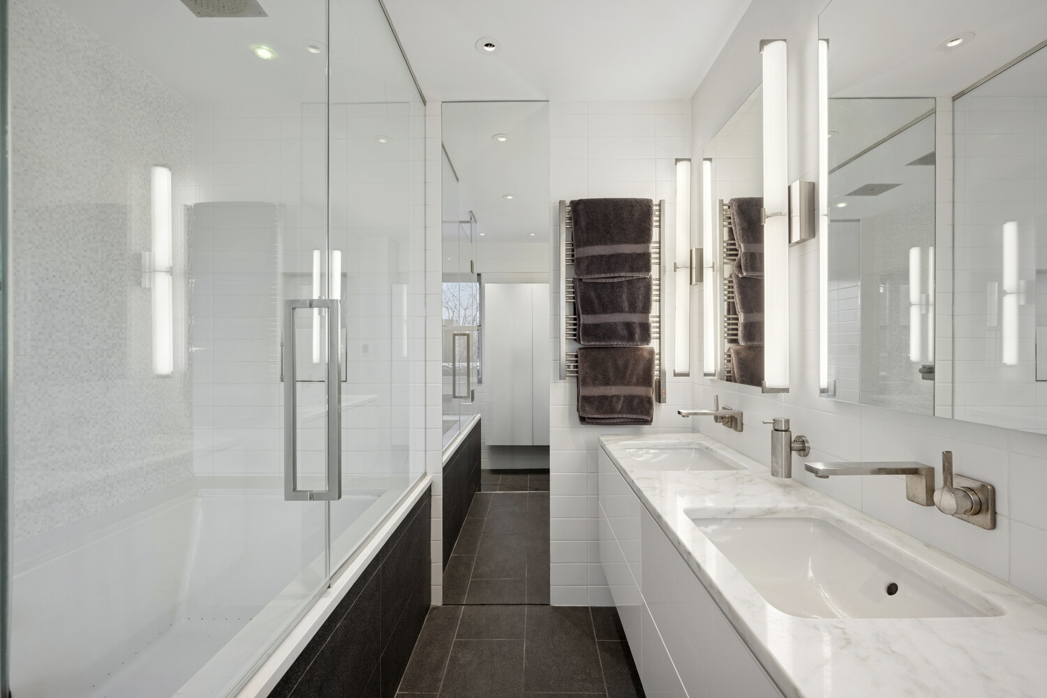 2 5th Avenue, Unit 14R Manhattan, NY 10011 - Photo 9 of 21 a bathroom with a double vanity sink a mirror and shower
