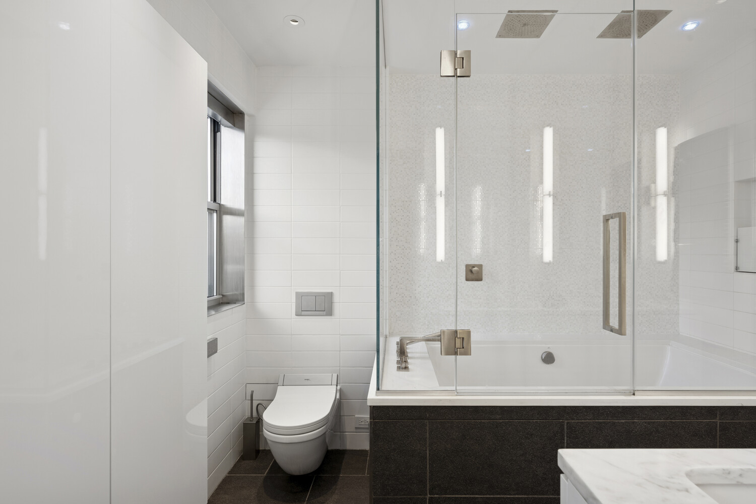 2 5th Avenue, Unit 14R Manhattan, NY 10011 - Photo 11 of 21 a bathroom with a sink a toilet and shower