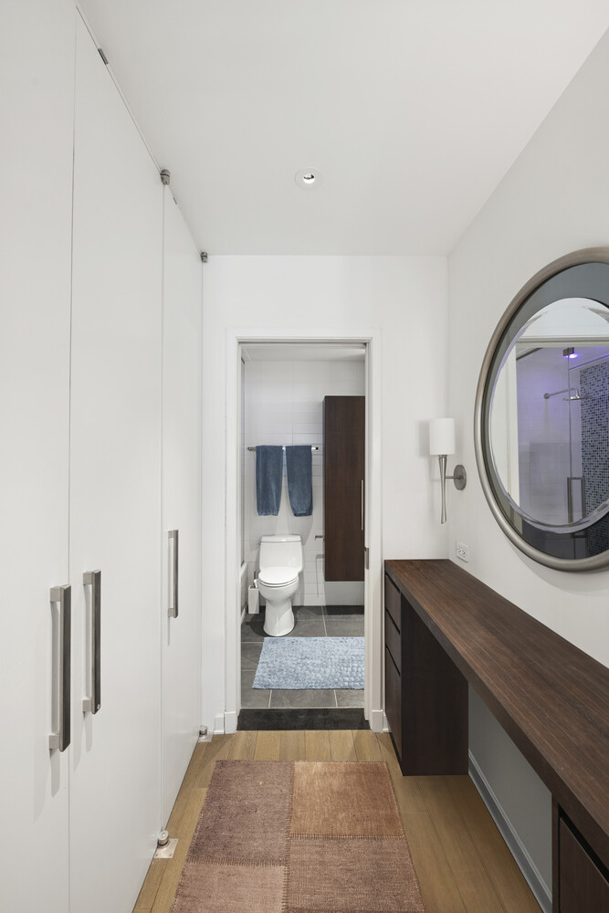 2 5th Avenue, Unit 14R Manhattan, NY 10011 - Photo 12 of 21 a living room with a mirror and a table