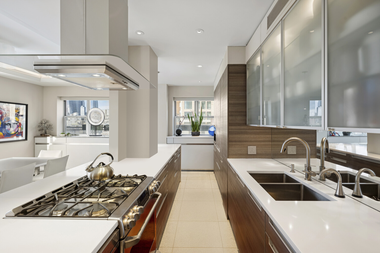2 5th Avenue, Unit 14R Manhattan, NY 10011 - Photo 6 of 21 a kitchen with a sink stove and cabinets