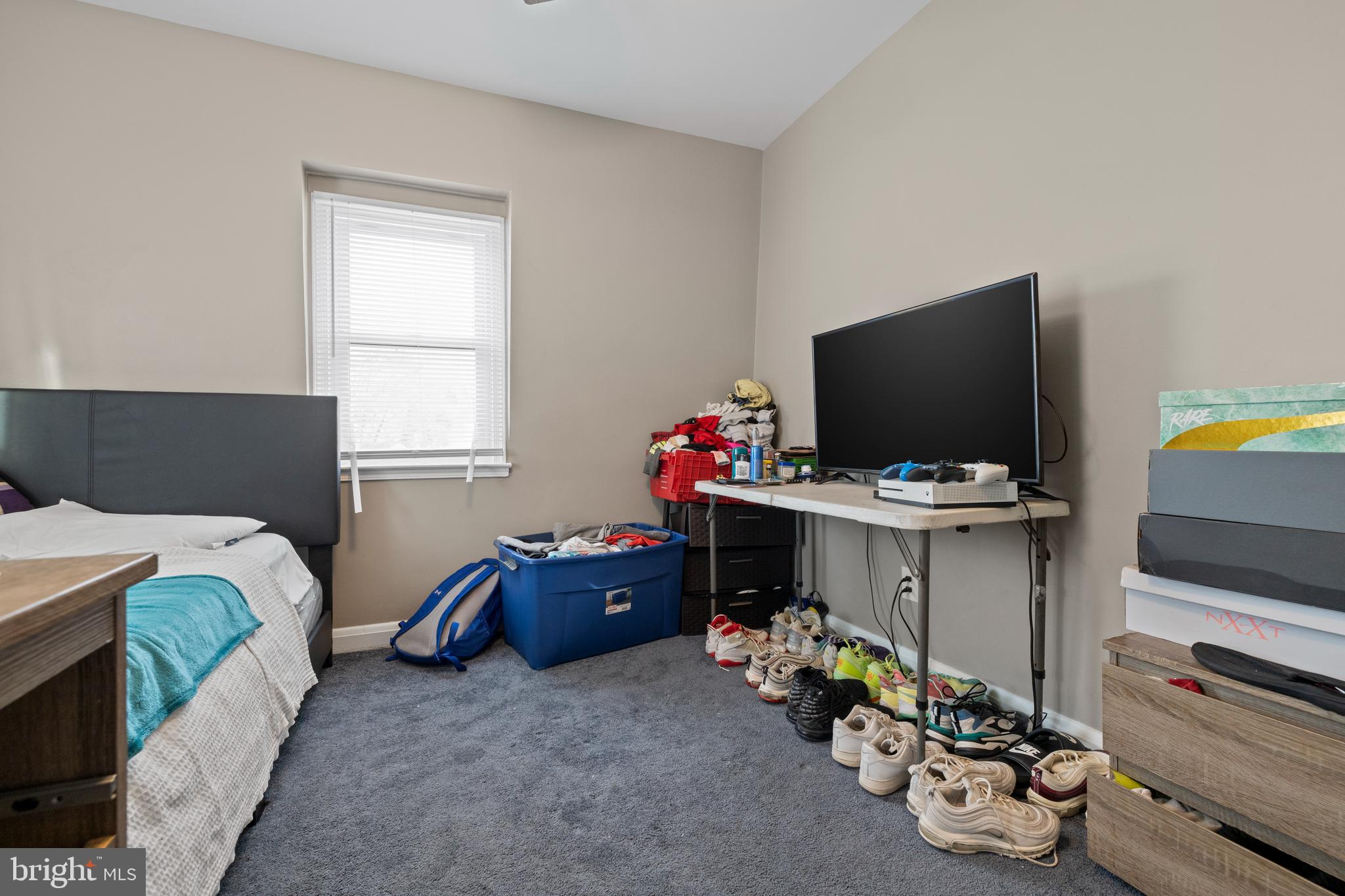 2717 Talbot Road Baltimore, MD 21216 - Photo 8 of 12 a bedroom with furniture and a flat screen tv