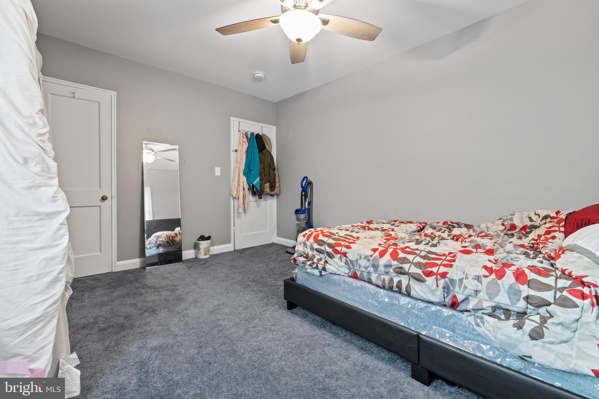 2717 Talbot Road Baltimore, MD 21216 - Photo 9 of 12 a bed room with a bed and a chandelier