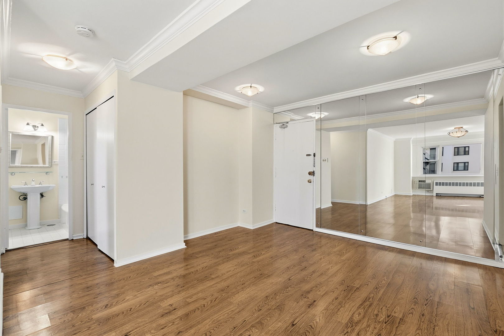 2909 North Sheridan Road, Unit 802 Chicago, IL 60657 - Photo 13 of 22 wooden floor in an empty room with a window
