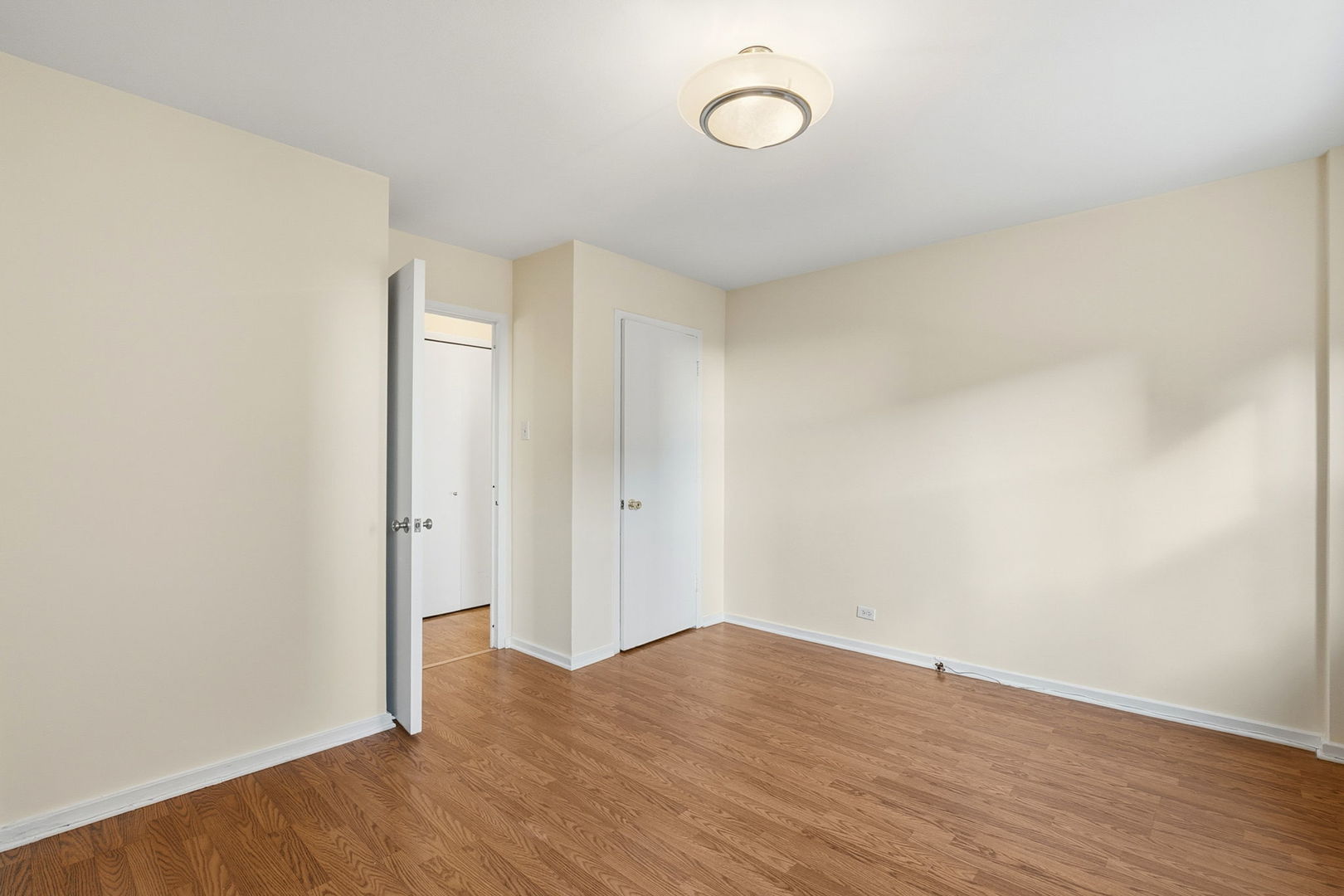 2909 North Sheridan Road, Unit 802 Chicago, IL 60657 - Photo 16 of 22 an empty room with wooden floor and windows