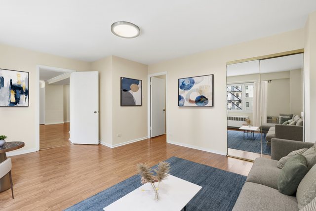 2909 North Sheridan Road, Unit 802 Chicago, IL 60657 - Photo 4 of 22 a living room with furniture and wooden floor