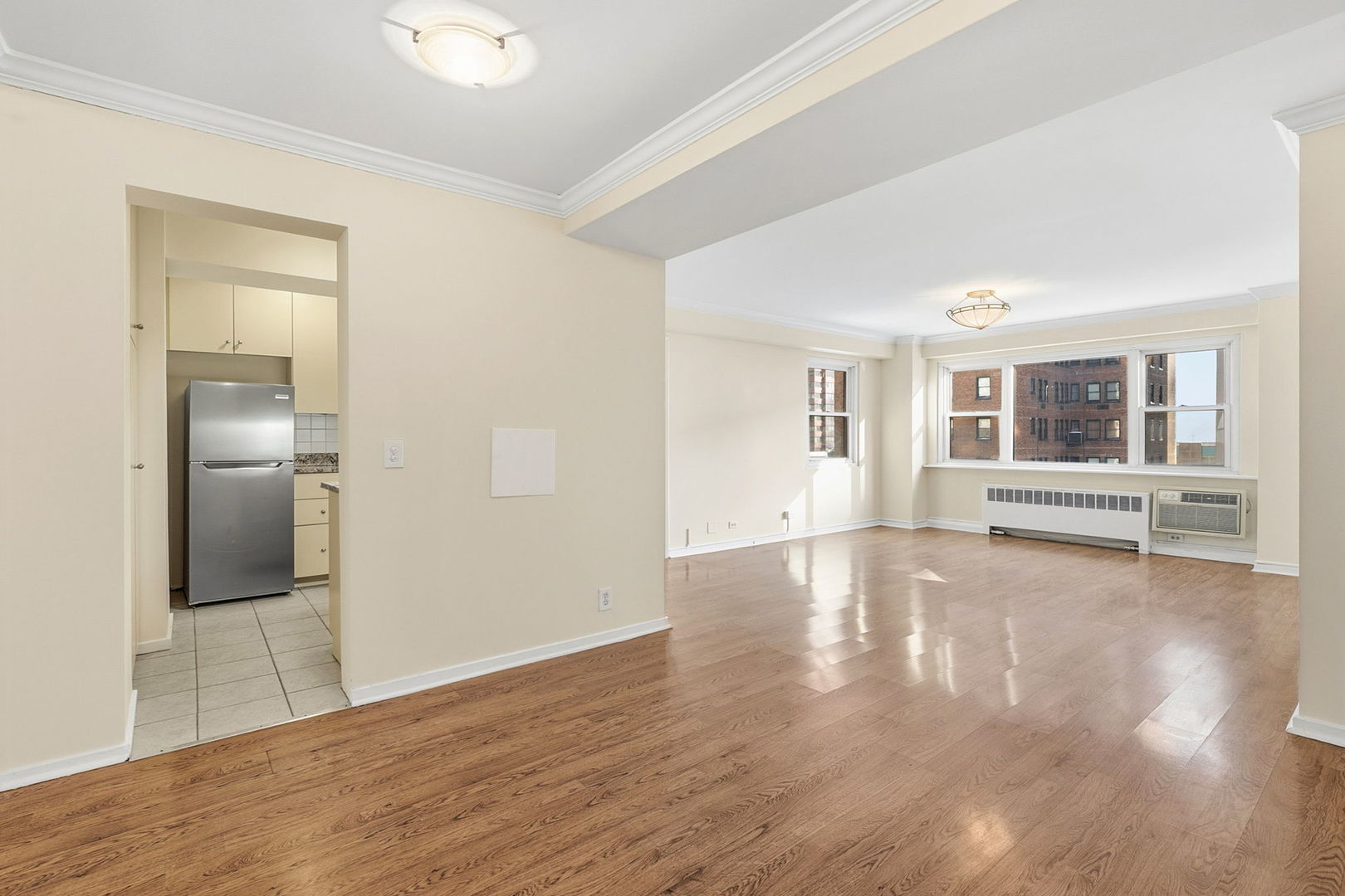 2909 North Sheridan Road, Unit 802 Chicago, IL 60657 - Photo 7 of 22 a view of empty room with wooden floor and fireplace