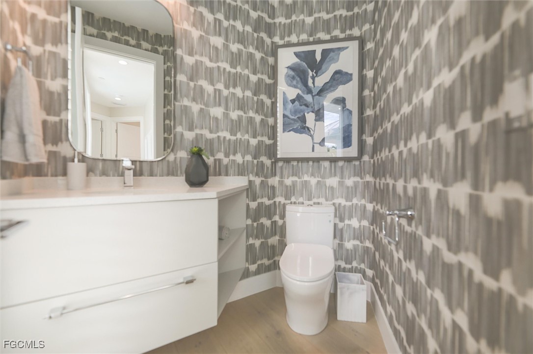 941 South Seas Plantation Road Captiva, FL 33924 - Photo 13 of 50 a bathroom with a toilet sink and mirror