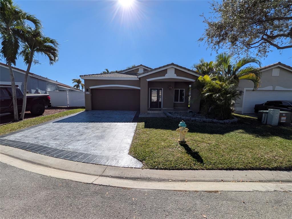 4572 Southwest 14th Street Deerfield Beach, FL 33442 - Photo 1 of 58 a view of a house with a yard and potted plants