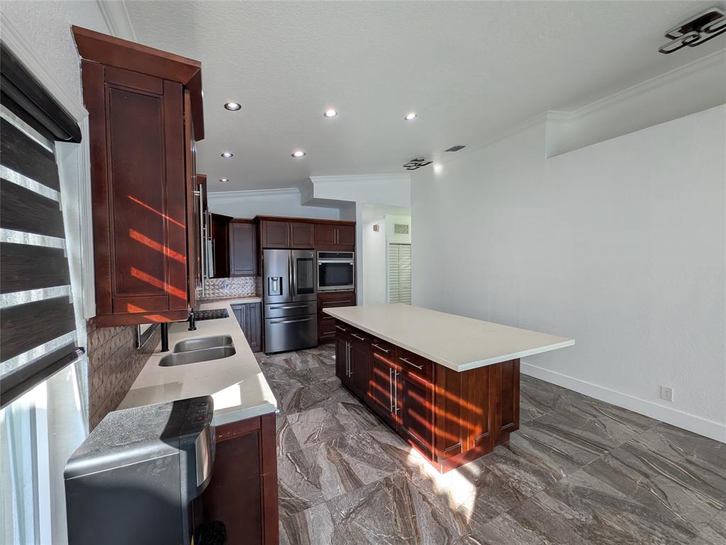 4572 Southwest 14th Street Deerfield Beach, FL 33442 - Photo 11 of 58 a living room with furniture pool table and kitchen view