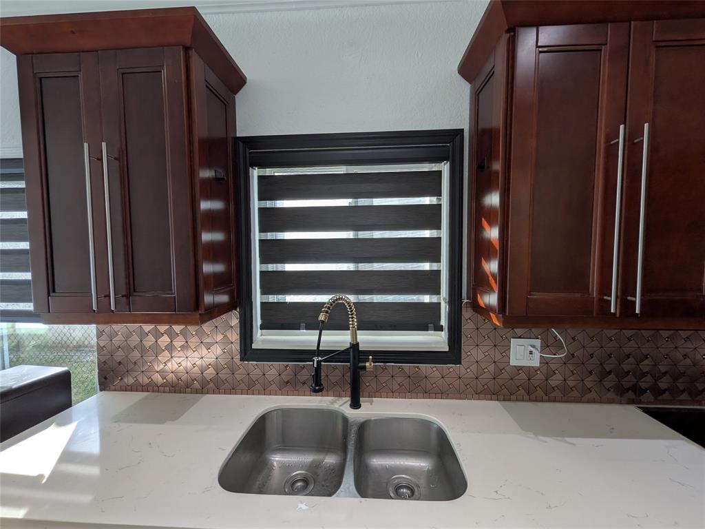 4572 Southwest 14th Street Deerfield Beach, FL 33442 - Photo 12 of 58 a kitchen with a sink and a refrigerator