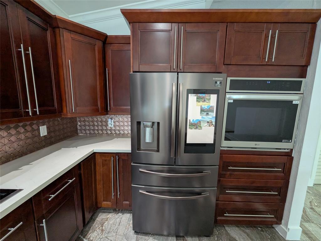 4572 Southwest 14th Street Deerfield Beach, FL 33442 - Photo 13 of 58 a kitchen with stainless steel appliances granite countertop a refrigerator and a sink