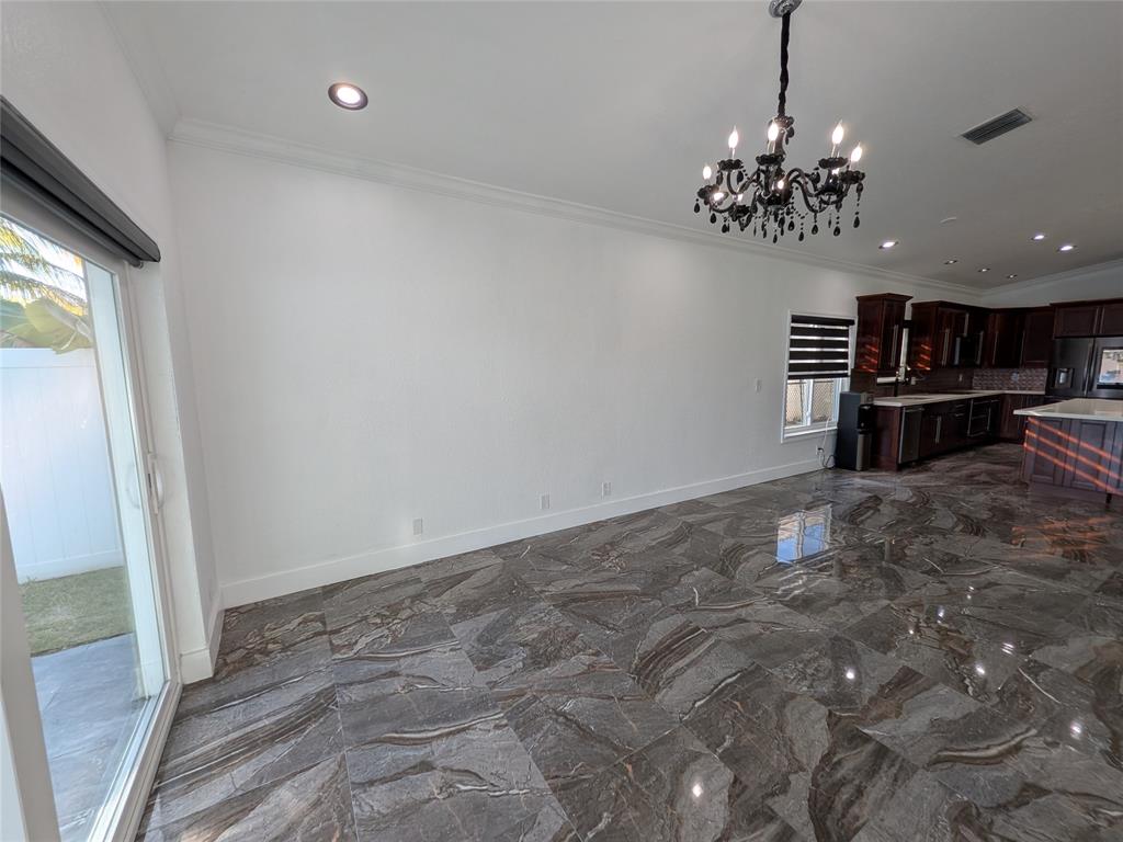 4572 Southwest 14th Street Deerfield Beach, FL 33442 - Photo 16 of 58 a view of a room with a chandelier