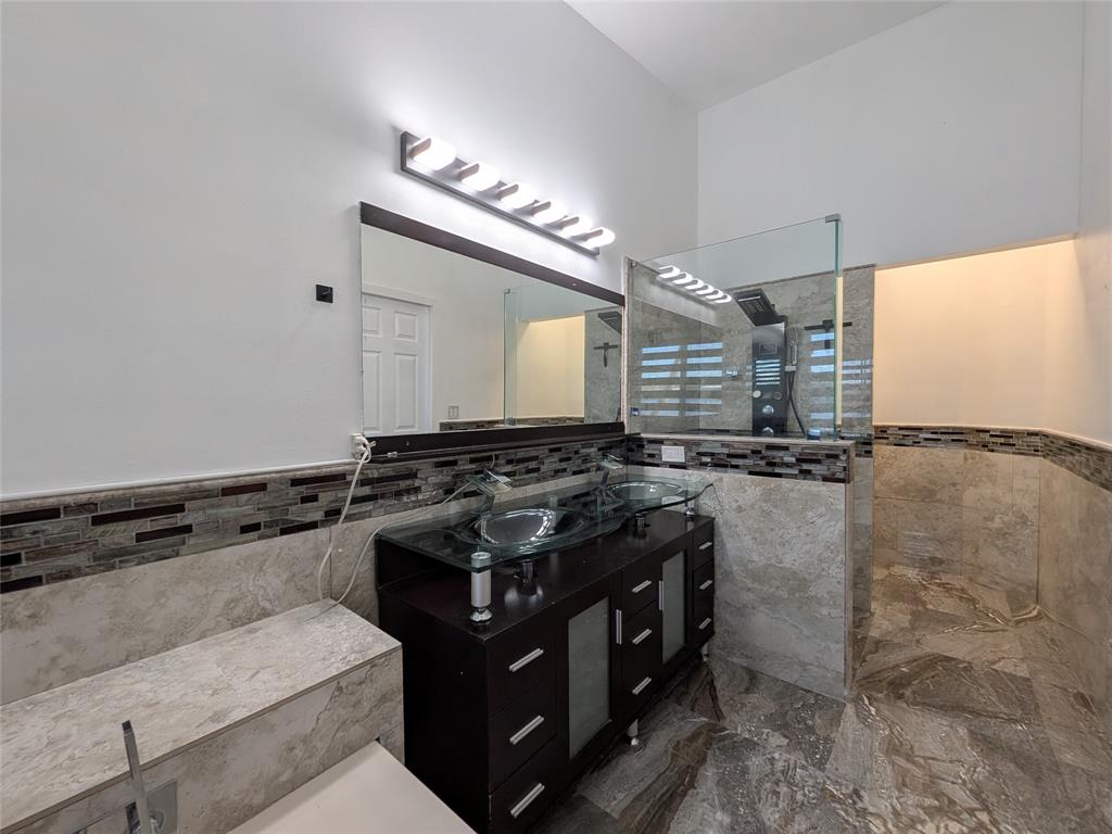 4572 Southwest 14th Street Deerfield Beach, FL 33442 - Photo 21 of 58 a kitchen with granite countertop a stove and a sink