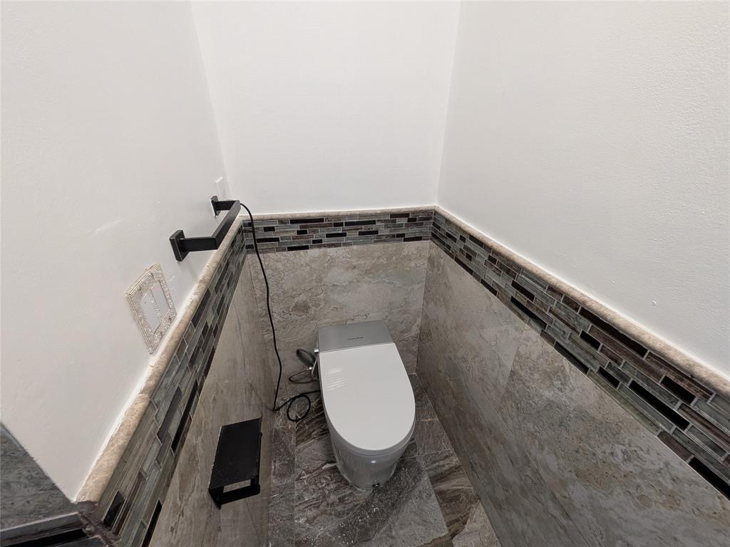 4572 Southwest 14th Street Deerfield Beach, FL 33442 - Photo 23 of 58 a bathroom with a toilet