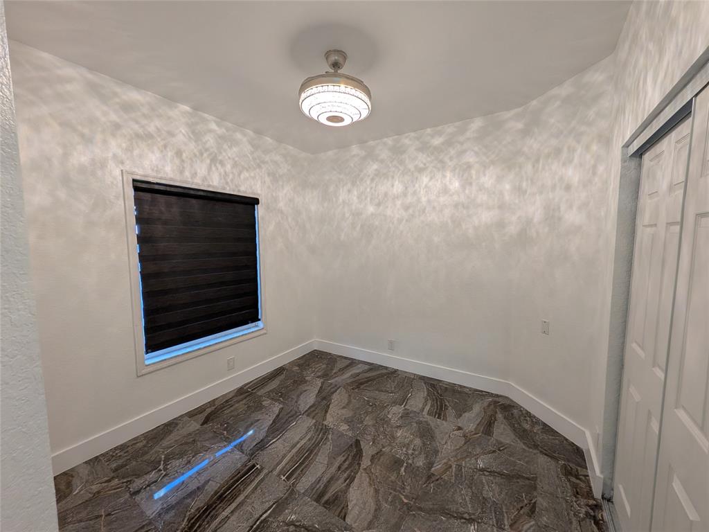 4572 Southwest 14th Street Deerfield Beach, FL 33442 - Photo 27 of 58 a view of an empty room with wooden floor and a window