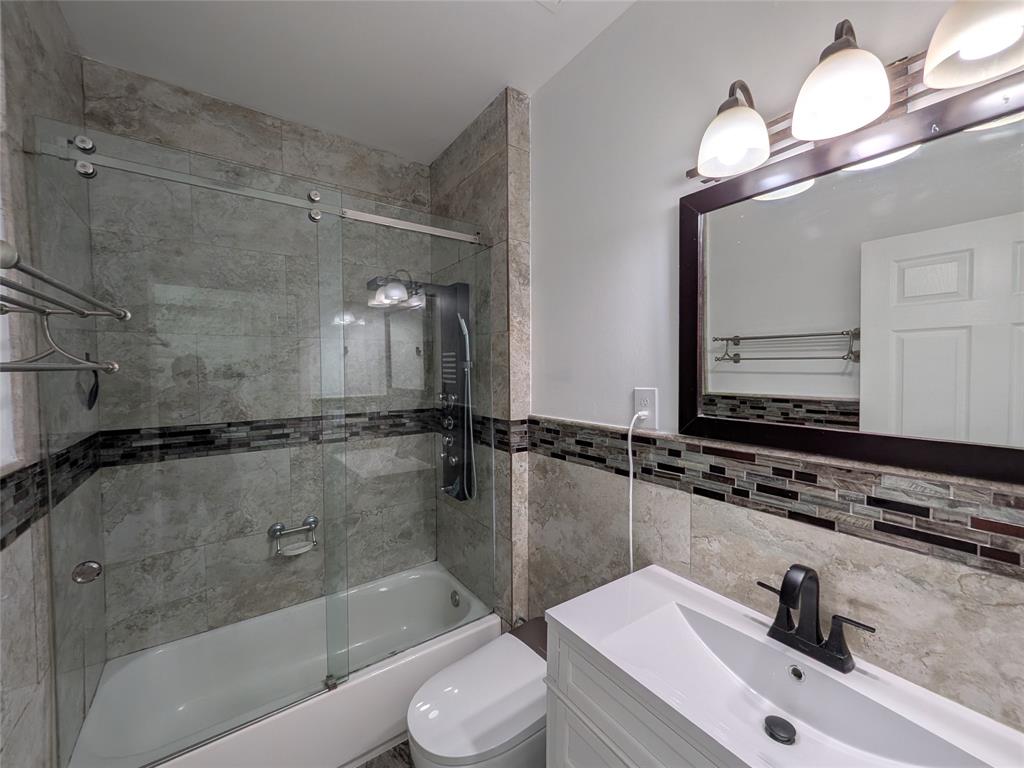 4572 Southwest 14th Street Deerfield Beach, FL 33442 - Photo 38 of 58 a bathroom with a sink a toilet and shower