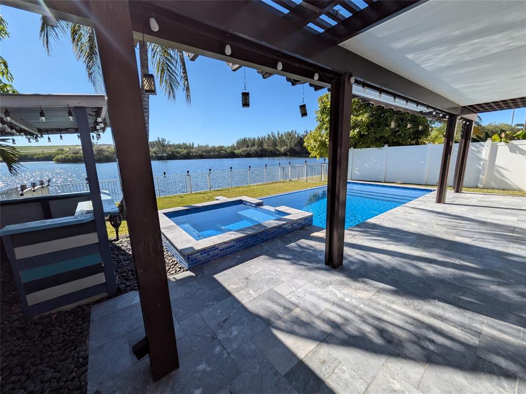 4572 Southwest 14th Street Deerfield Beach, FL 33442 - Photo 43 of 58 a view of swimming pool with a lounge chairs
