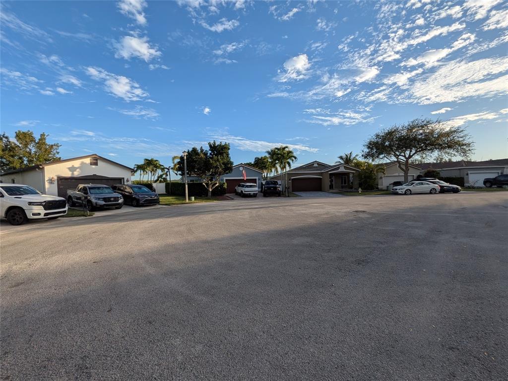 4572 Southwest 14th Street Deerfield Beach, FL 33442 - Photo 48 of 58 a view of car parked on the side of a street