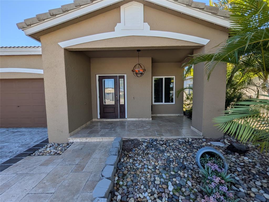 4572 Southwest 14th Street Deerfield Beach, FL 33442 - Photo 57 of 58 a front view of a house with garden