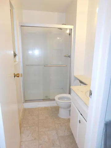 a bathroom with a toilet and a shower