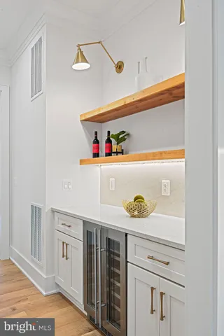 a kitchen with stainless steel appliances kitchen island granite countertop a kitchen island and chairs in it