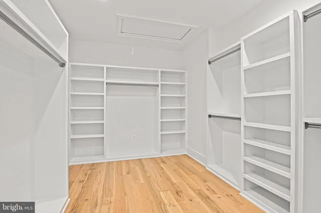 a kitchen with kitchen island a sink stainless steel appliances and cabinets