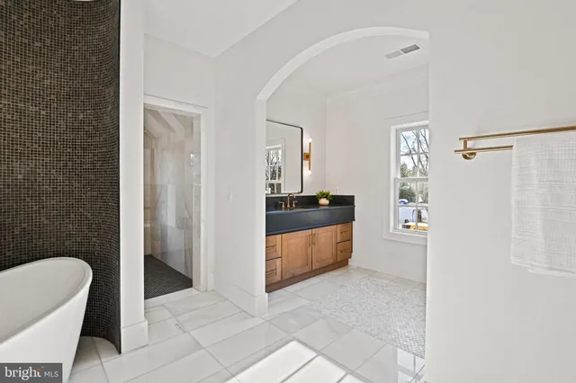 a utility room with a sink and a wooden floor