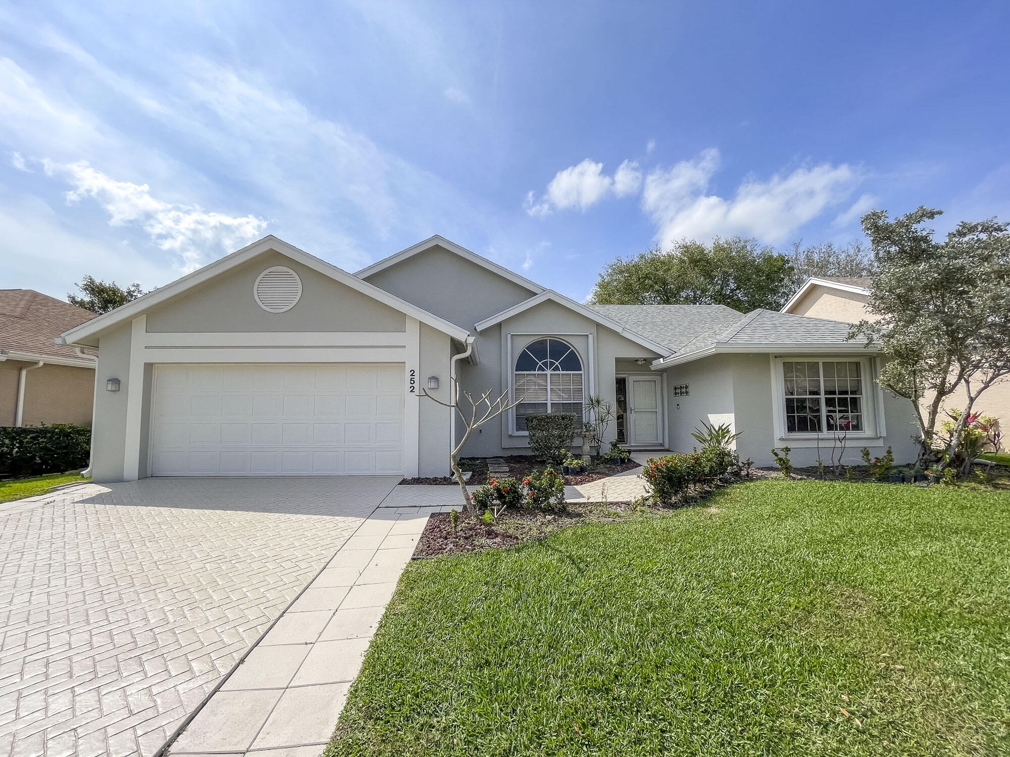 252 Moccasin Trail West Jupiter, FL 33458 - Photo 1 of 24 a front view of a house with sitting space and garden
