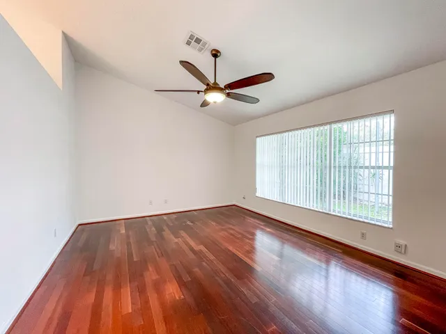 wooden floor in an empty room with a window