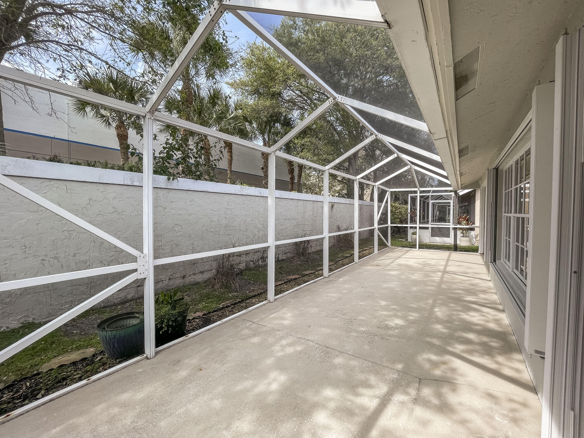 252 Moccasin Trail West Jupiter, FL 33458 - Photo 20 of 24 a view of an empty room with wooden floor and windows