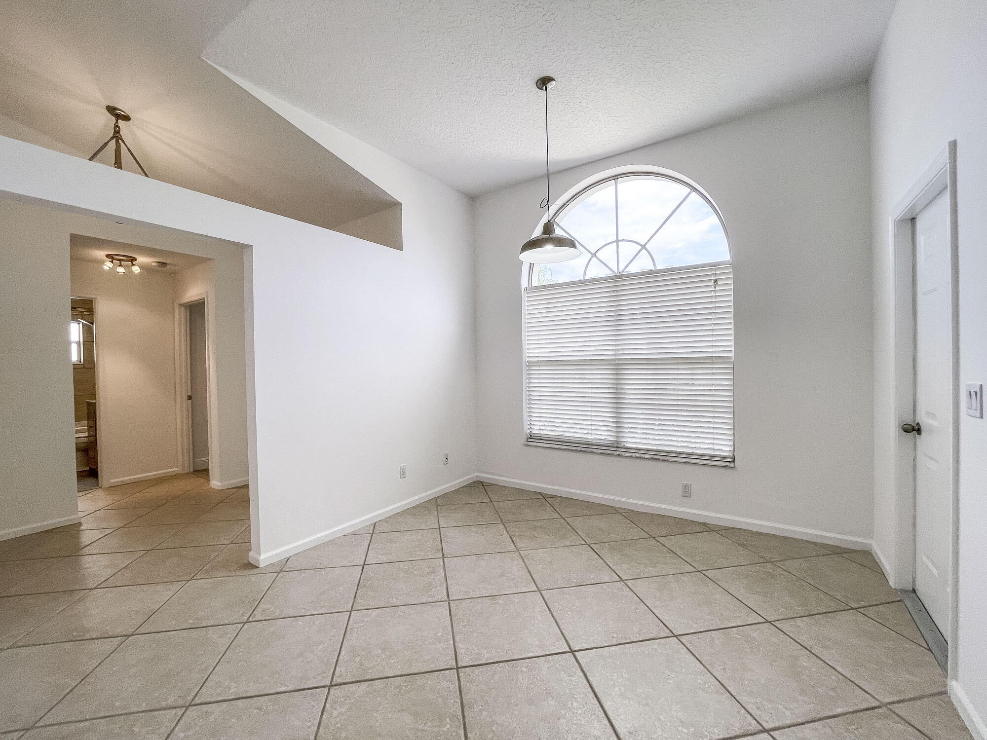 252 Moccasin Trail West Jupiter, FL 33458 - Photo 7 of 24 an empty room with a mirror and windows