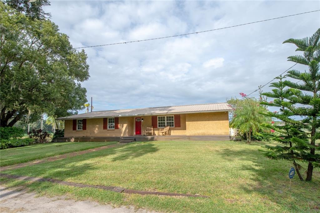 13058 Gore Road Dover, FL 33527 - Photo 1 of 1 a view of house with a yard