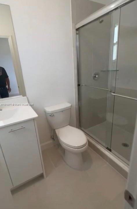 12147 Northwest 23rd Court Miami, FL 33167 - Photo 13 of 19 a white toilet sitting next to a shower