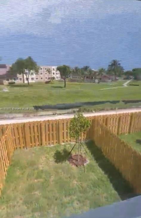 12147 Northwest 23rd Court Miami, FL 33167 - Photo 14 of 19 a view of a lake with a building in the background