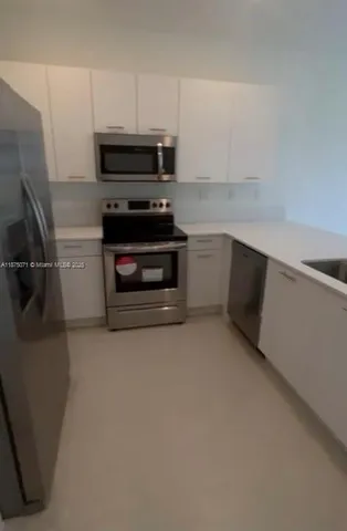 a kitchen with appliances and cabinets