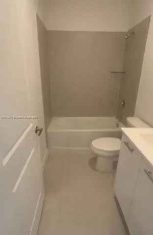 a bathroom with a toilet and a bath tub