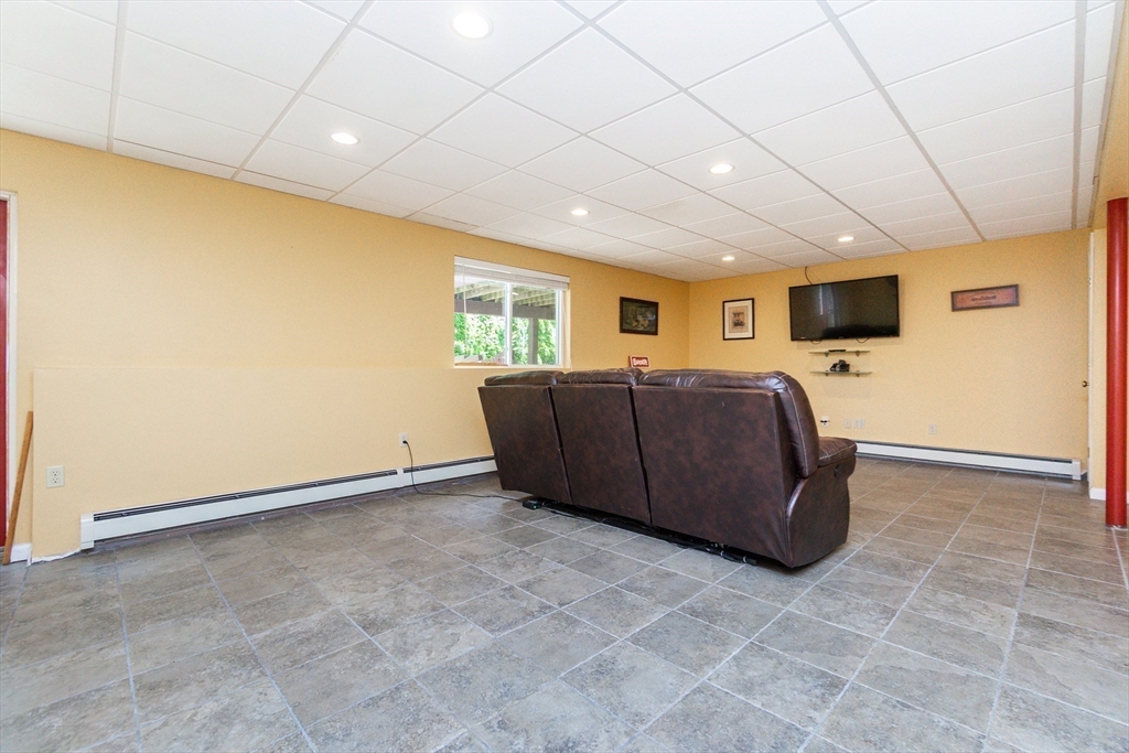 63 Bow Street Saugus, MA 01906 - Photo 30 of 42 a living room with a couch and a flat screen tv