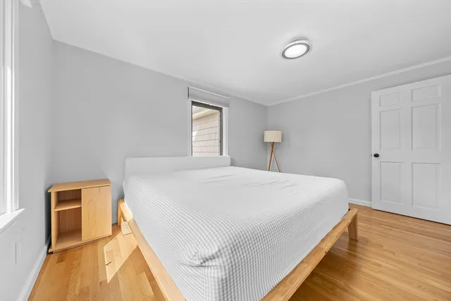 a bedroom with a bed and a night stand