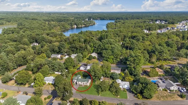 an aerial view of a house with a yard