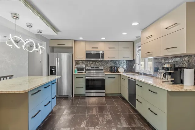 a kitchen with stainless steel appliances granite countertop a refrigerator sink and cabinets