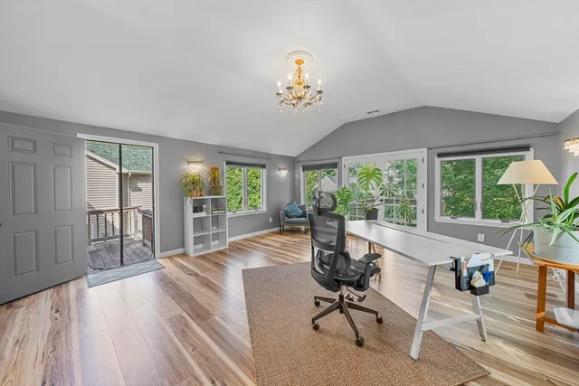 a view of a livingroom with furniture wooden floor and a rug