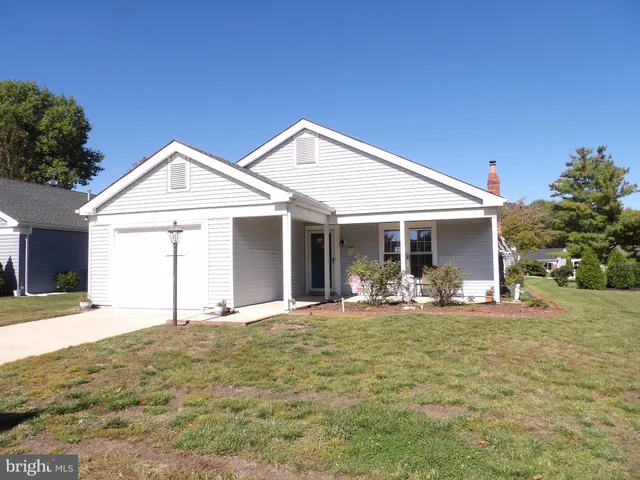 a front view of a house with yard and porch