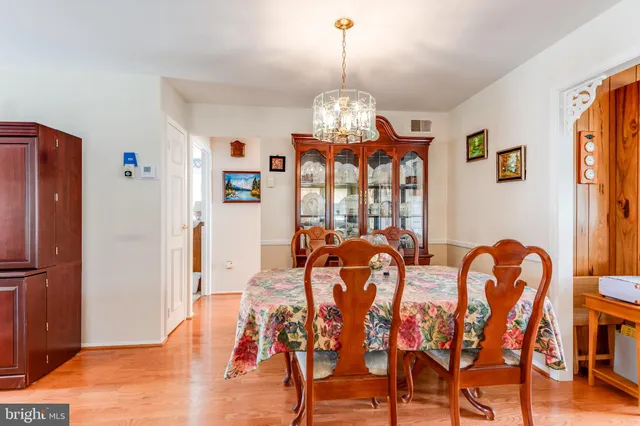 a view of a dining room with furniture wooden floor and chandelier